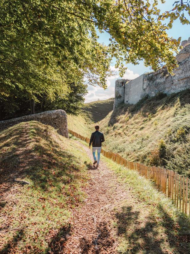 Jeune homme de dos se baladant autour des ruines du château d'Arques-la-Bataille